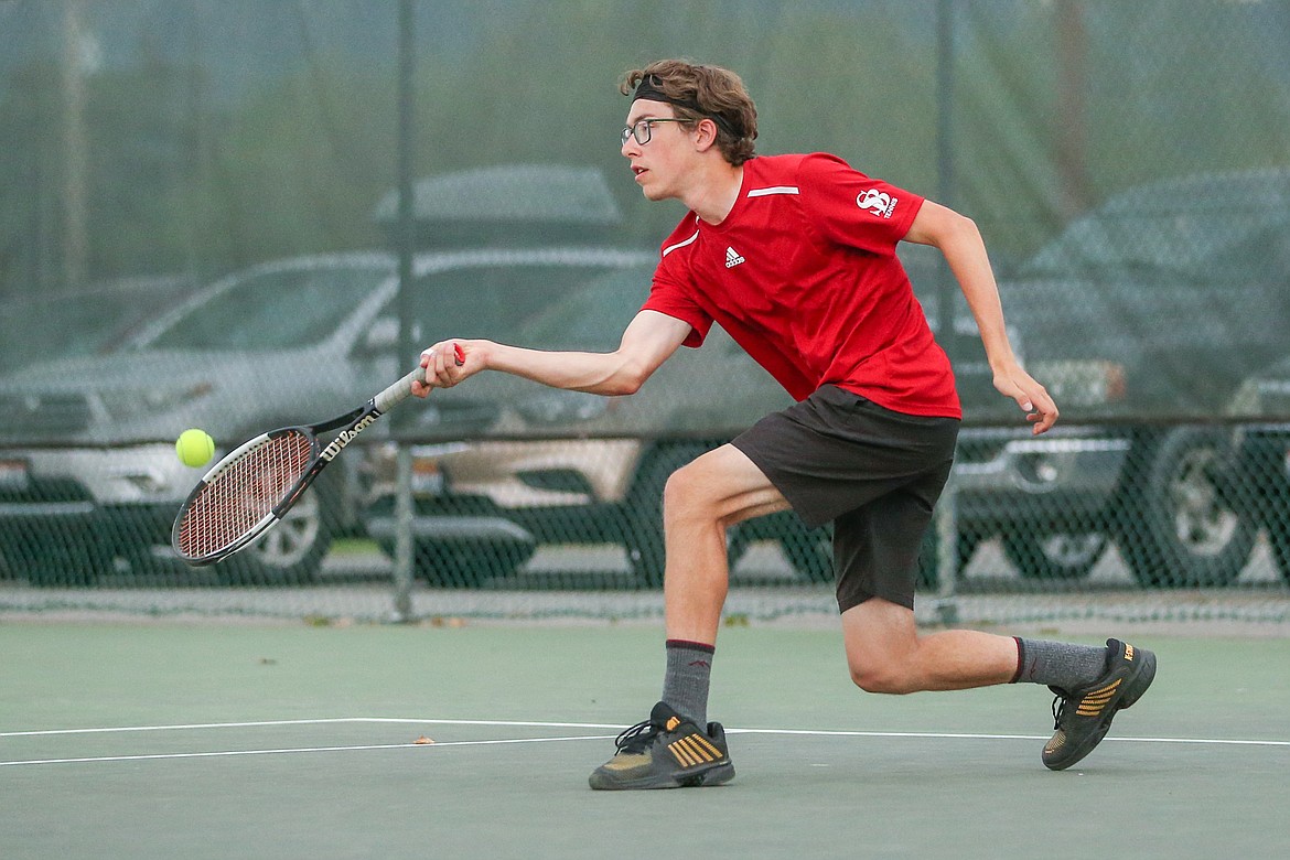 Ivan Steinbachs gets low to the ground in order to return a ball in a match against Post Falls earlier this season.