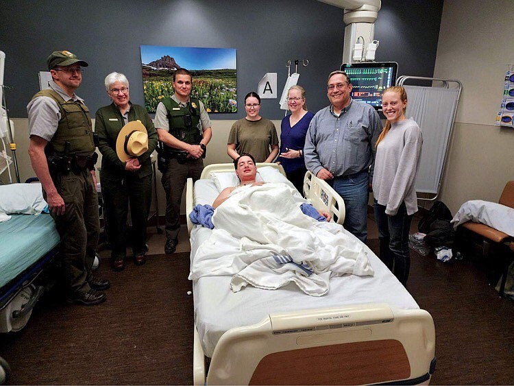 19-year-old Matthew Read at Logan Health in Kalispell, surrounded by rescue crew members who helped locate him while he was missing in Glacier National Park. (photo provided)