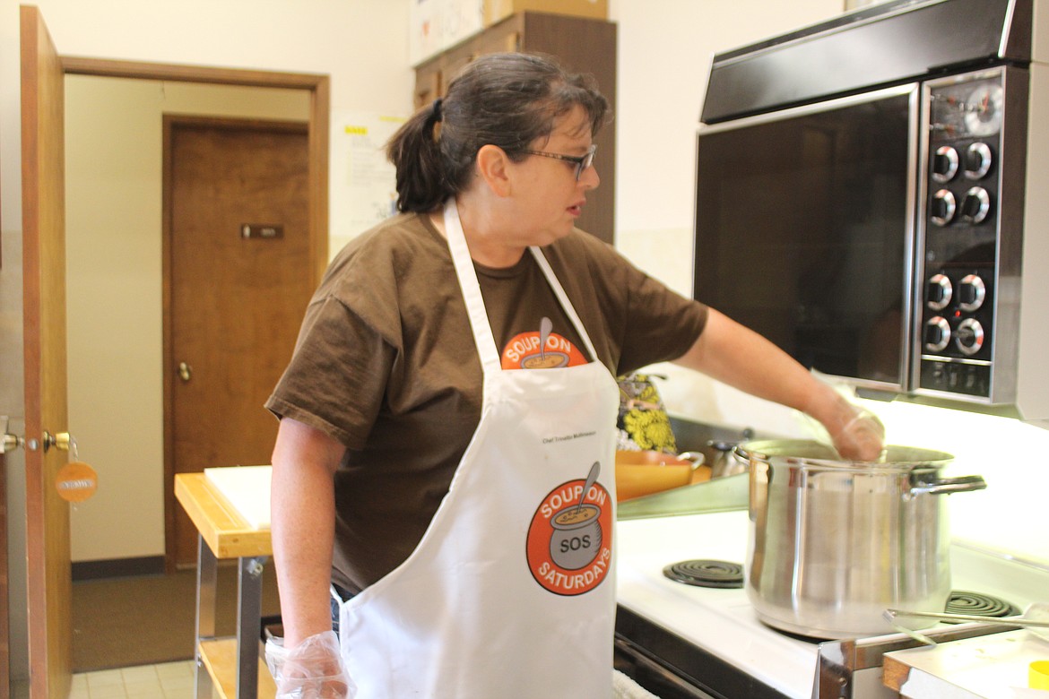 Trinette Mullineaux stirs the soup pot, preparing the main course for the Soup on Saturdays project.