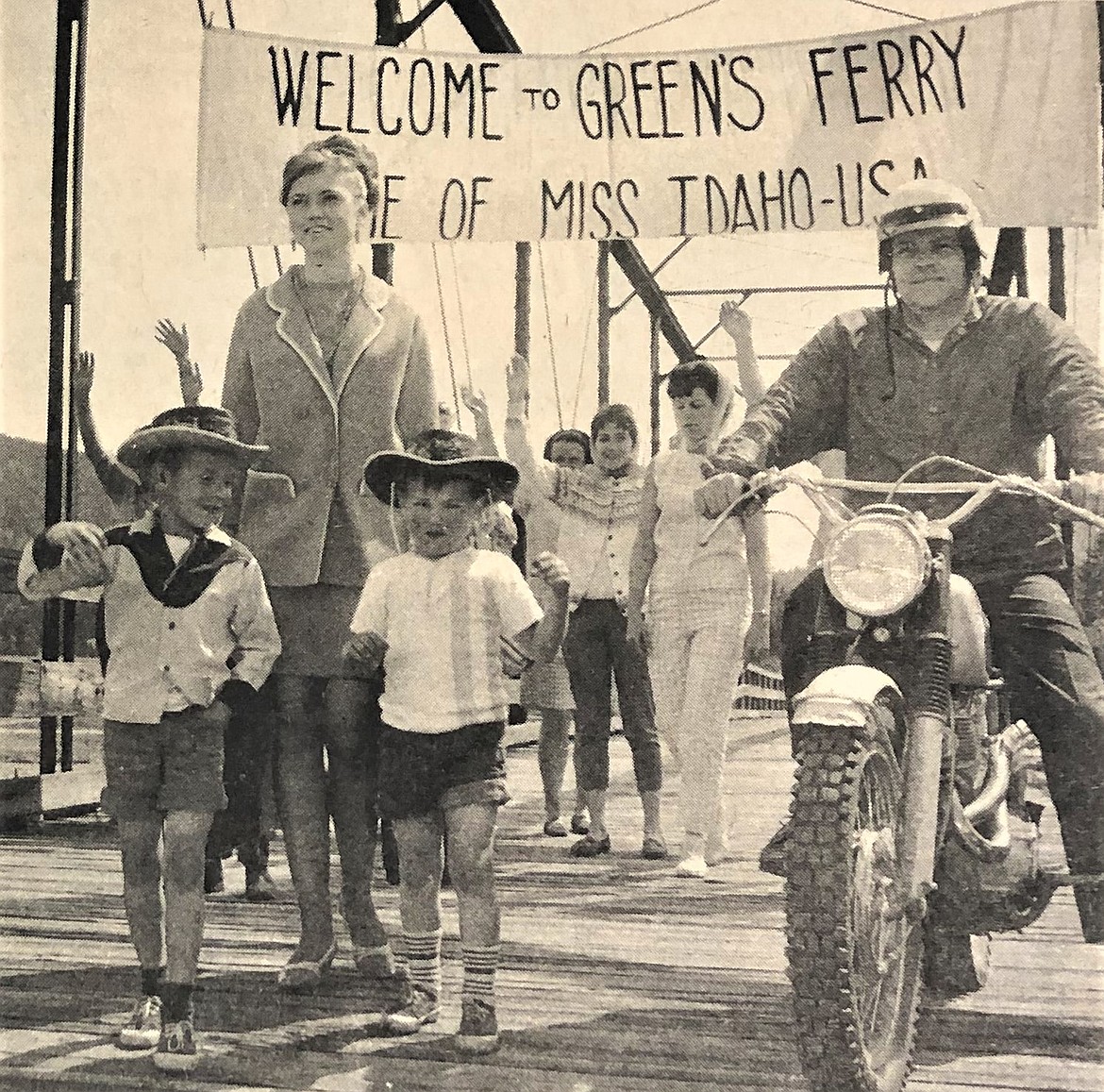 Anna Marie Evenson is escorted across the Green's Ferry bridge by her neighbors.