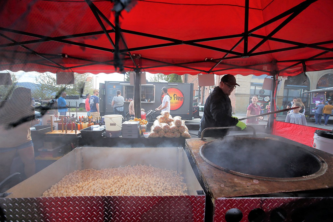 Colton Houlihan prepares a batch of kettle corn at the 5th Street Farmers Market on Wednesday.