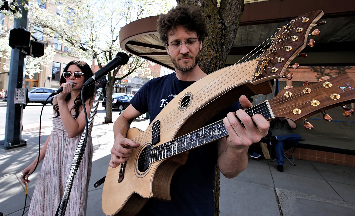 The musical duo of David Powell and Courtney Riddle perform during the 5th Street Farmers Market on Wednesday.