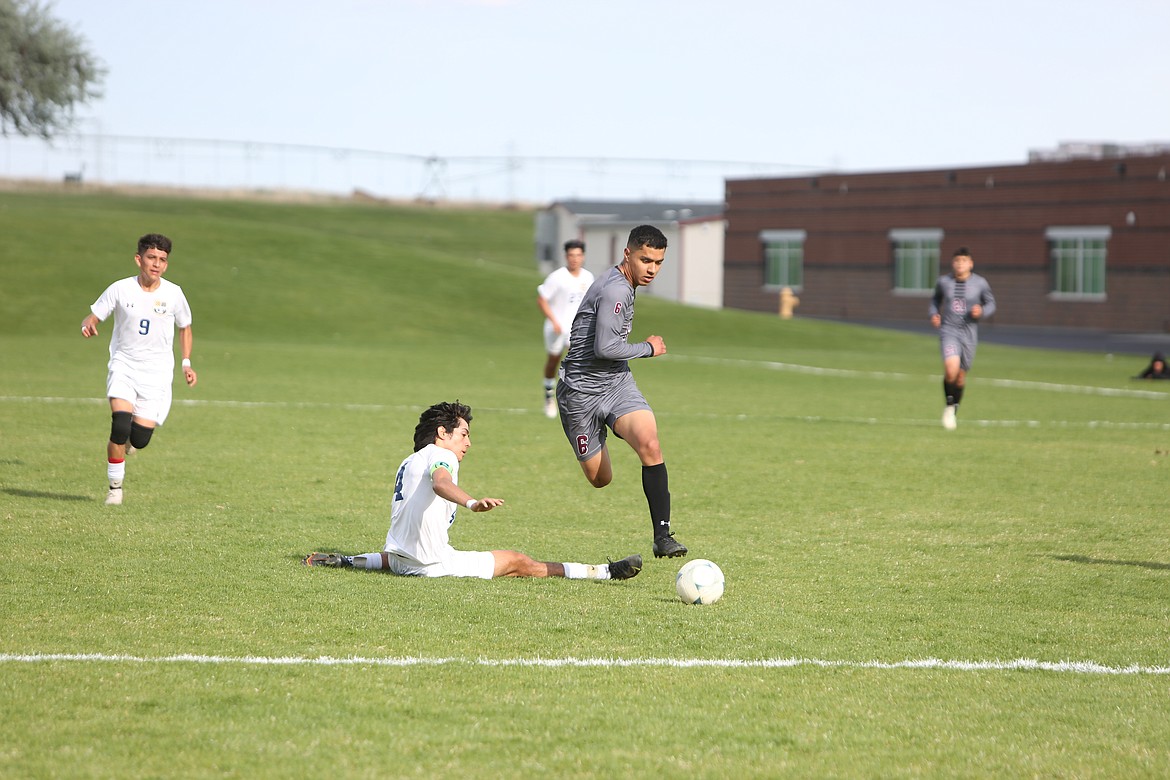 Wahluke senior Juan Bravo jumps a Wolves defender en route toward a shot on the Wapato net.