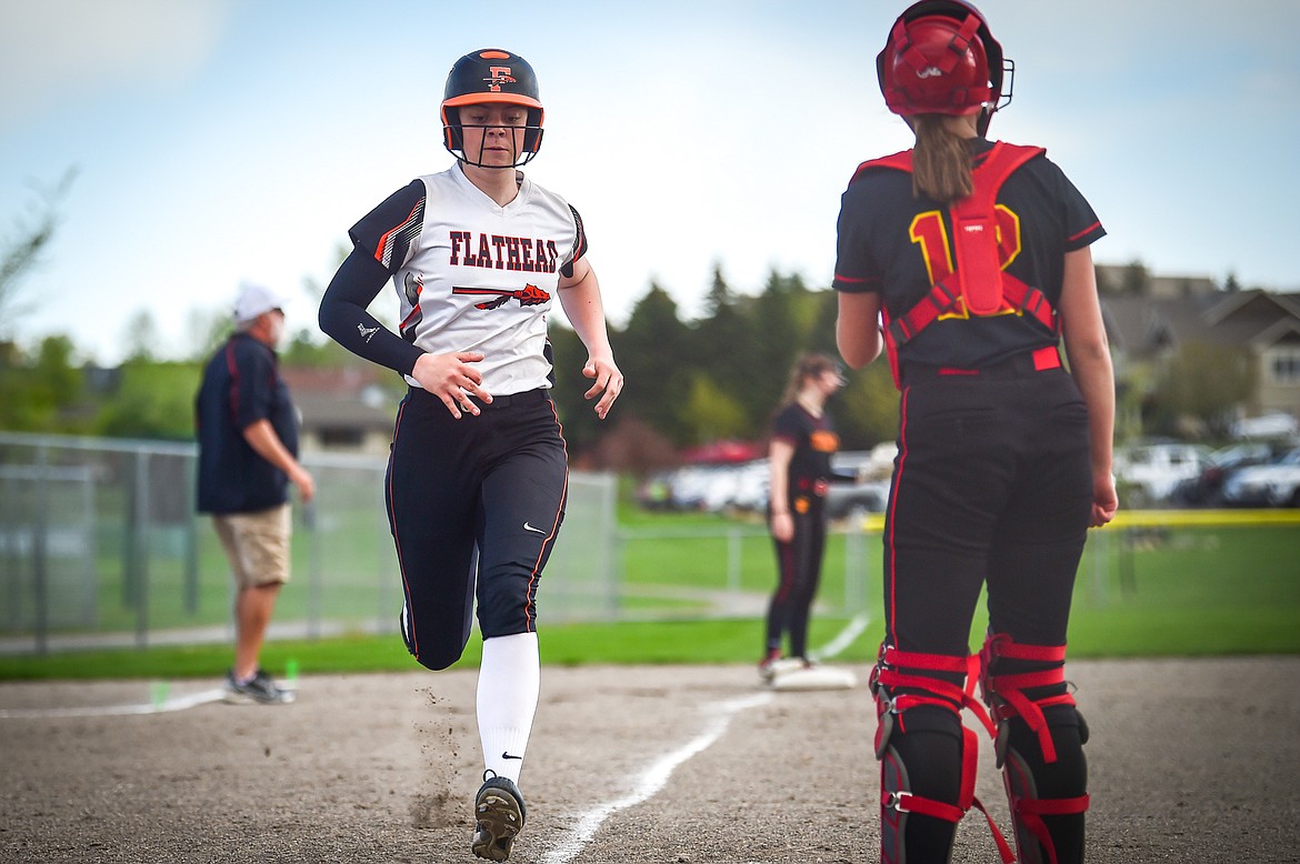 Flathead's Kaidyn Lake (10) is brought home by Macey McIlhargey (3) in the first inning against Missoula Hellgate at Kidsports on Thursday, May 11. (Casey Kreider/Daily Inter Lake)