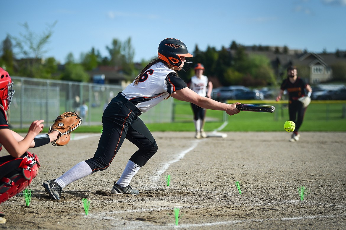 Flathead's Ava Besson (16) scores Mackenzie Brandt from third with a sacrifice bunt in the fourth inning against Missoula Hellgate at Kidsports on Thursday, May 11. (Casey Kreider/Daily Inter Lake)