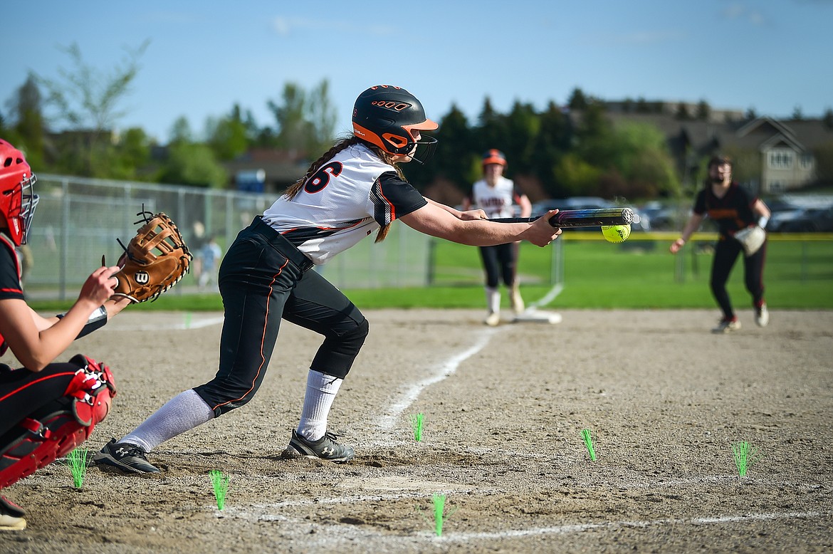 Flathead's Ava Besson (16) scores Mackenzie Brandt from third with a sacrifice bunt in the fourth inning against Missoula Hellgate at Kidsports on Thursday, May 11. (Casey Kreider/Daily Inter Lake)