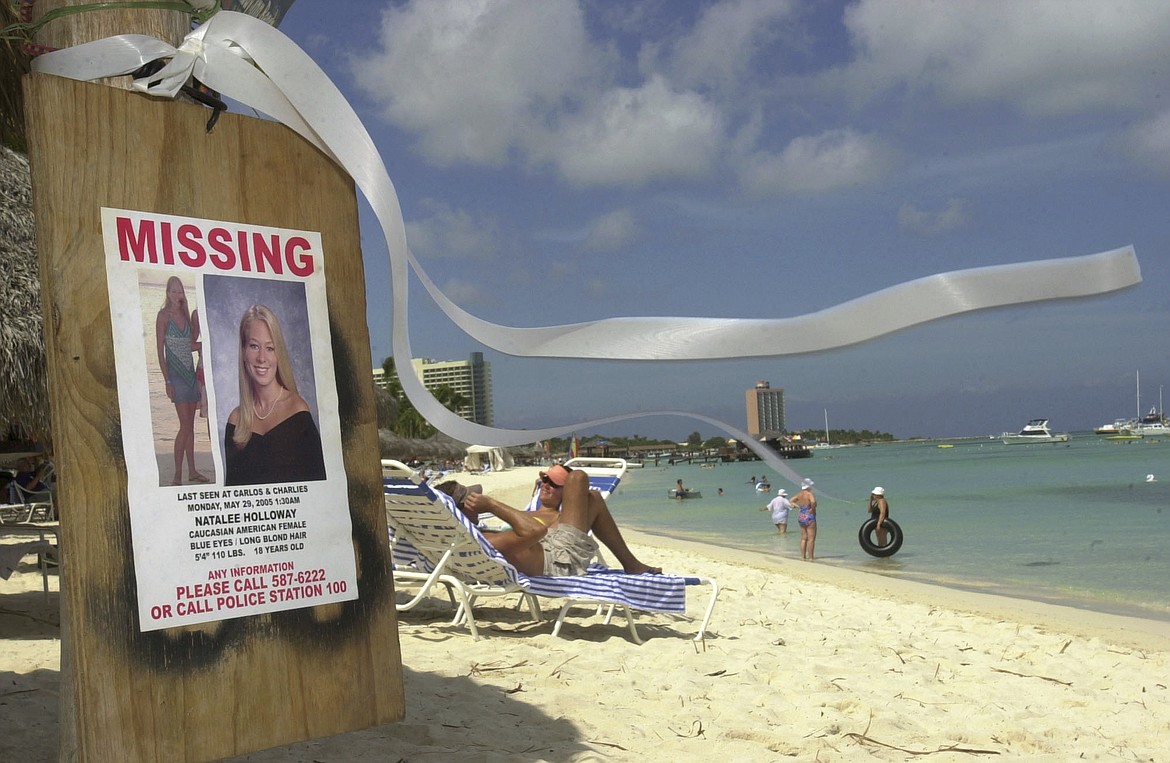 A sign of Natalee Holloway, an Alabama high school graduate who disappeared while on a graduation trip to Aruba, is seen on Palm Beach, in front of her hotel in Aruba, Friday, June 10, 2005, as a ribbon in her memory blows in the breeze. The government of Peru on Wednesday, May 10, 2023, issued an executive order allowing the temporary extradition to the United States of Joran van der Sloot, the prime suspect in the unsolved 2005 disappearance of Natalee Holloway. (AP Photo/Leslie Mazoch, File)