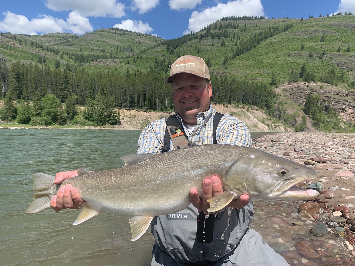 Ben Eisinger holds a bull trout he caught in the Hungry Horse Reservoir in June 2020. (Photo courtesy of Ben Eisinger)