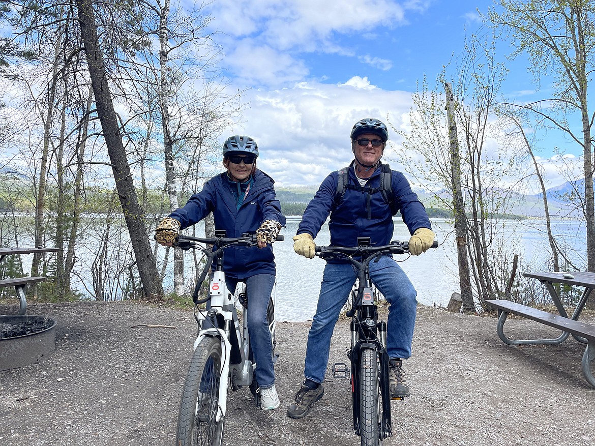 Jeff and Jo Thornberry of Utah take in Glacier National Park from the saddles of their rented e-bikes on May 10, 2023. (Adrian Knowler/Daily Inter Lake)