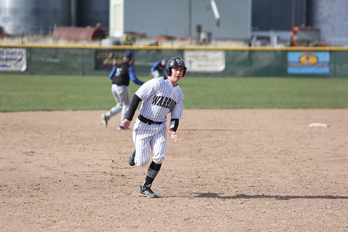 ACH junior Everett Wood runs to third base during a game against Columbia (Hunters) on April 18 . The Warriors finished the regular season with a 15-0 record.