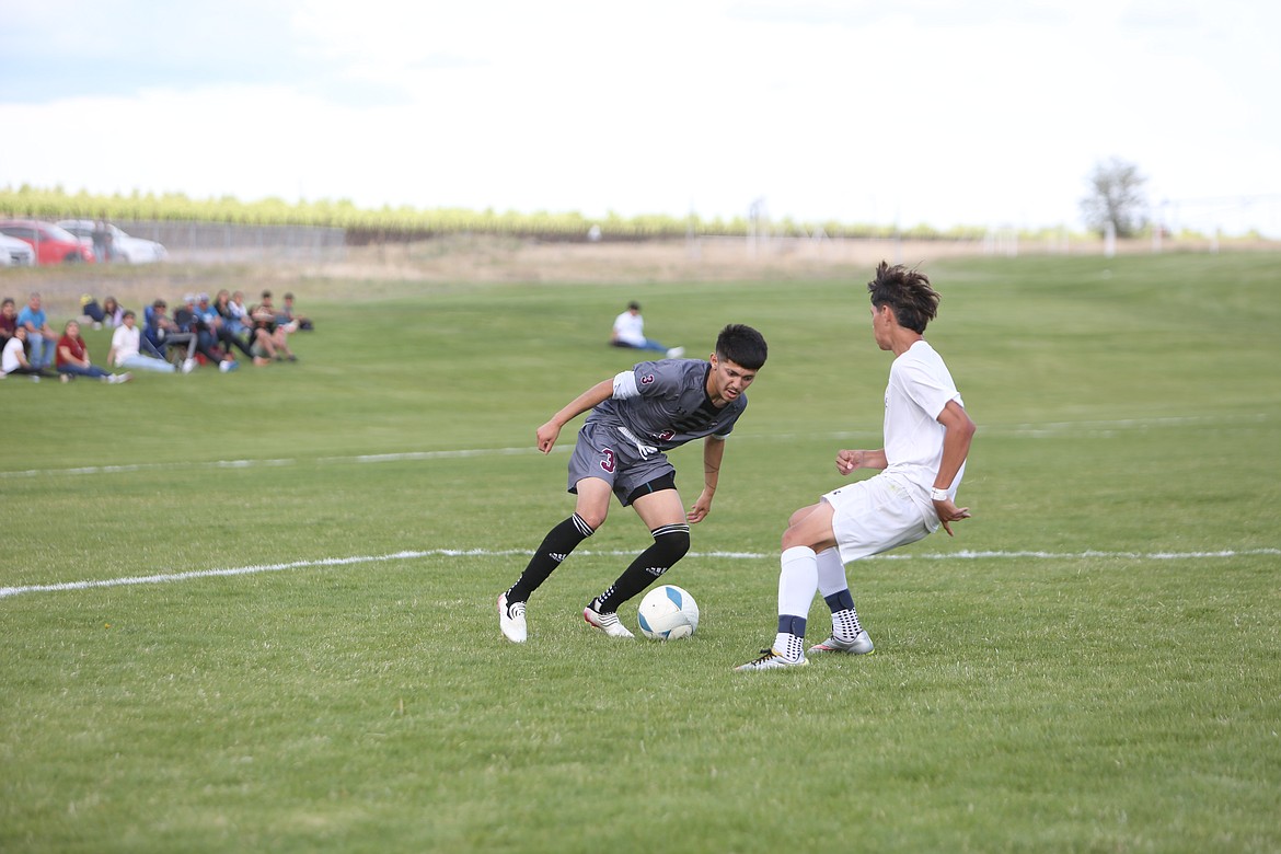 Wahluke senior Luis Garcia attempts to shake past a Wapato defender during the Warriors’ 5-0 win over the Wolves on Tuesday.