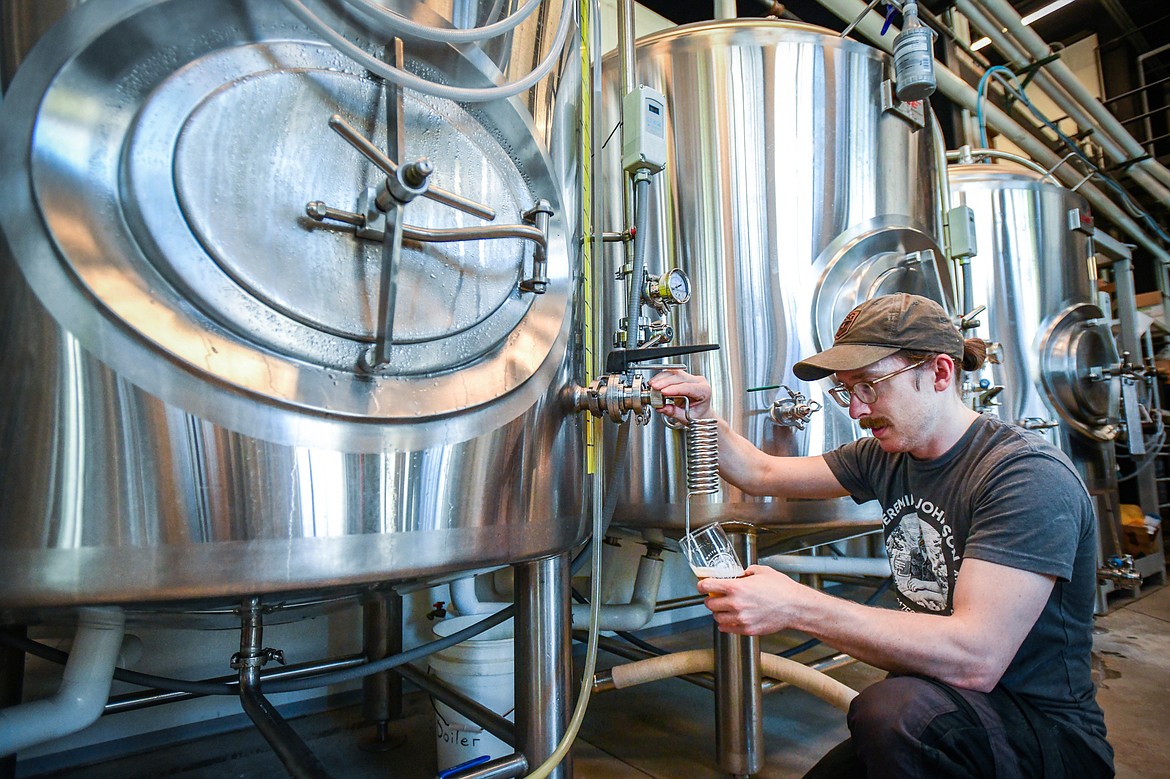 Head brewer Alex Johnson conducts a sensory analysis and tests carbonation levels before packaging at Blackstar in Whitefish on Thursday, May 11. (Casey Kreider/Daily Inter Lake)