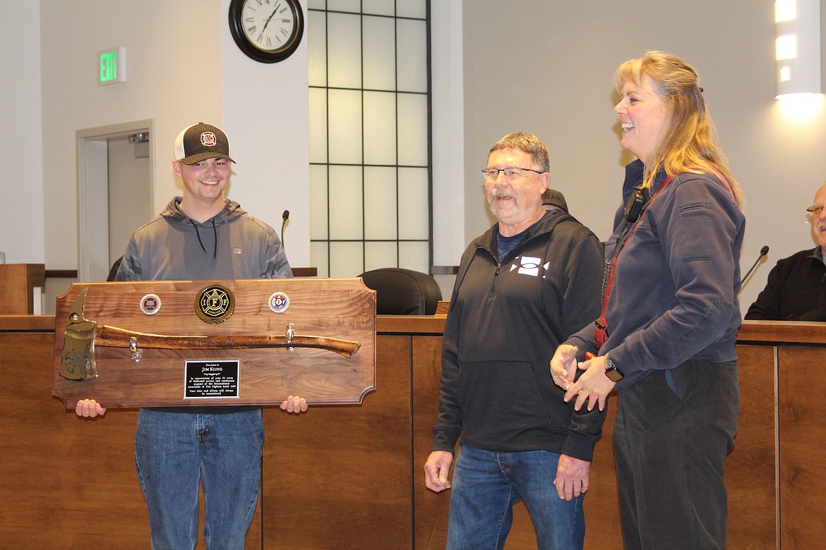 Michele Talley, right, and Casey Severin, left, of GCFD 3 present an award to Jim Kling, center, after his retirement in January. Talley said Kling provided and still provides support as she became the fire marshal.