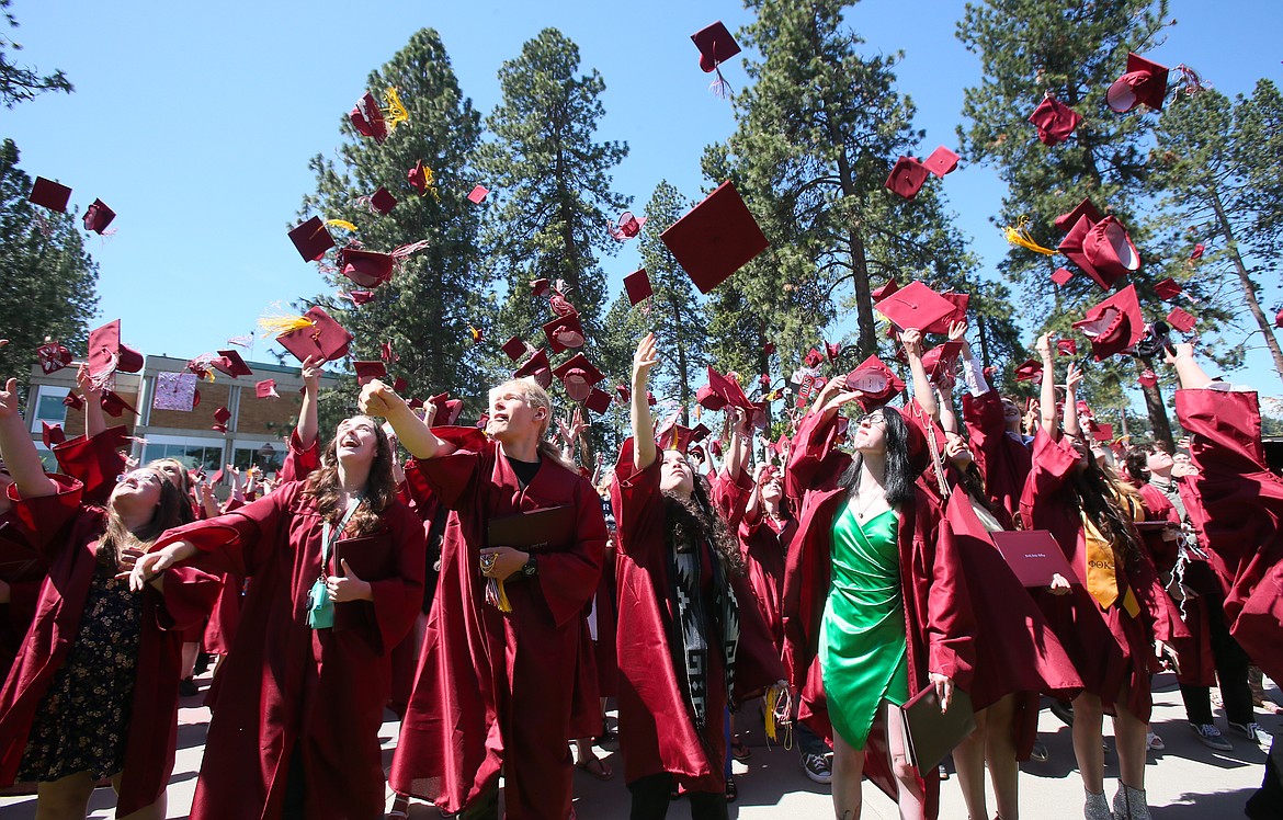 North Idaho College graduates toss their mortarboards into the sky on a sunny Friday in celebration of graduation.