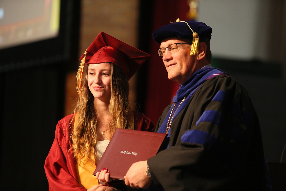 North Idaho College President Nick Swayne presents dual credit graduate Mischa Breazile with her degree Friday morning during the 2023 commencement ceremony. Breazile was among 126 dual credit students to earn degrees or certificates this year.