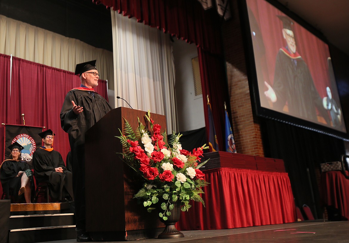 Business management and entrepreneurship assistant professor Dean Miles delivers the commencement speech Friday during North Idaho College's graduation ceremony.