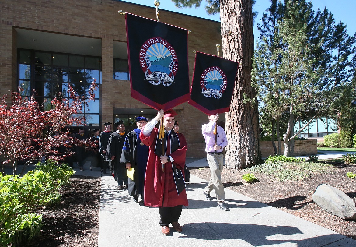 Outgoing ASNIC President Damian Maxwell on Friday leads the graduate march from Boswell Hall to the Christianson Gym as commencement festivities begin.