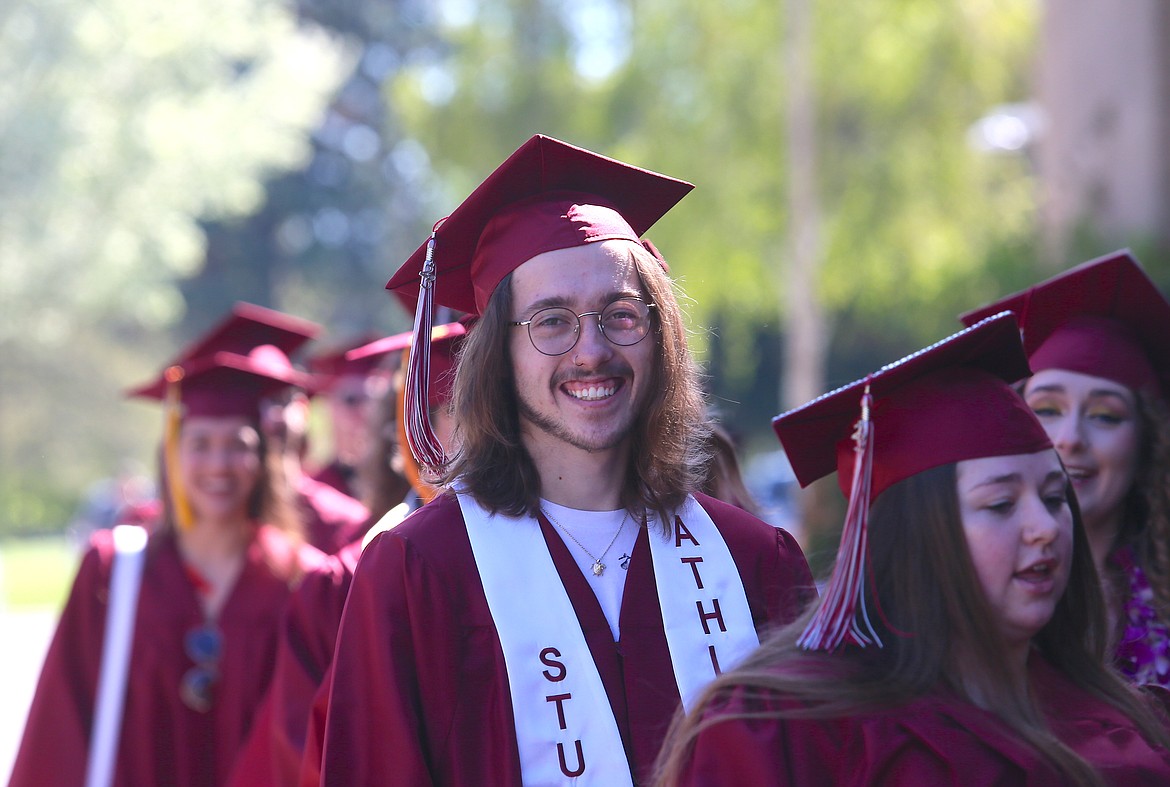 North Idaho College graduate Jayden Yoast-Gomes beams a smile Friday morning as he walks into the 2023 commencement ceremony in the gym.