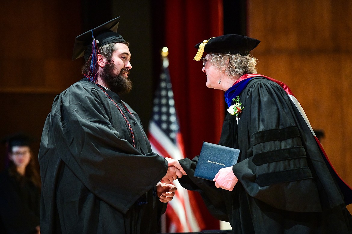 Dr. Chris Clouse, Vice President of Academic and Student Affairs, presents Michael Bruner with his degree at Flathead Valley Community College's Class of 2023 commencement ceremony inside McClaren Hall at the Wachholz College Center on Friday, May 12. A total of 268 graduates were honored receiving 288 degrees and certificates. (Casey Kreider/Daily Inter Lake)