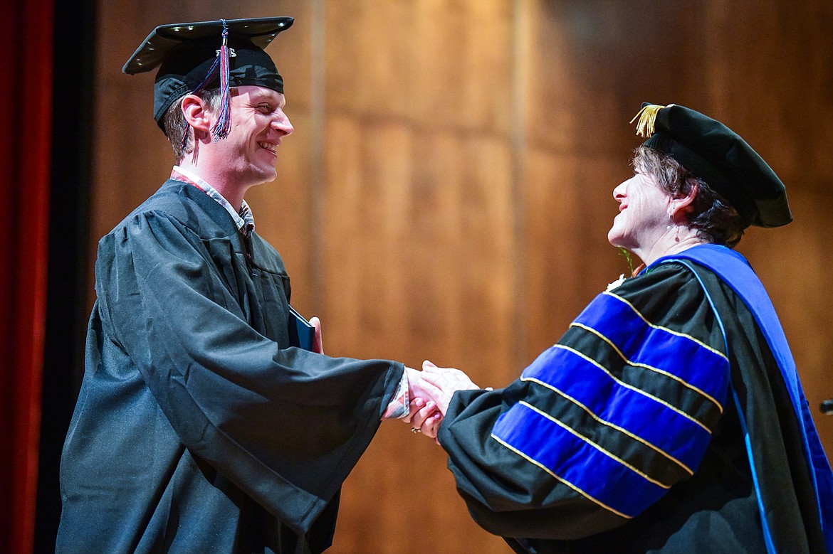 Flathead Valley Community College President Dr. Jane Karas shakes the hand of a graduate after receiving his degree at FVCC's Class of 2023 commencement ceremony inside McClaren Hall at the Wachholz College Center on Friday, May 12. A total of 268 graduates were honored receiving 288 degrees and certificates. (Casey Kreider/Daily Inter Lake)