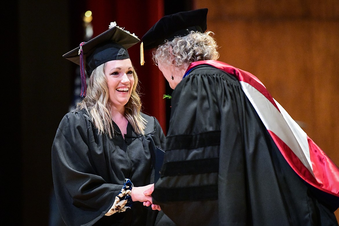 Dr. Chris Clouse, Vice President of Academic and Student Affairs, presents a graduate with her degree at Flathead Valley Community College's Class of 2023 commencement ceremony inside McClaren Hall at the Wachholz College Center on Friday, May 12. A total of 268 graduates were honored receiving 288 degrees and certificates. (Casey Kreider/Daily Inter Lake)