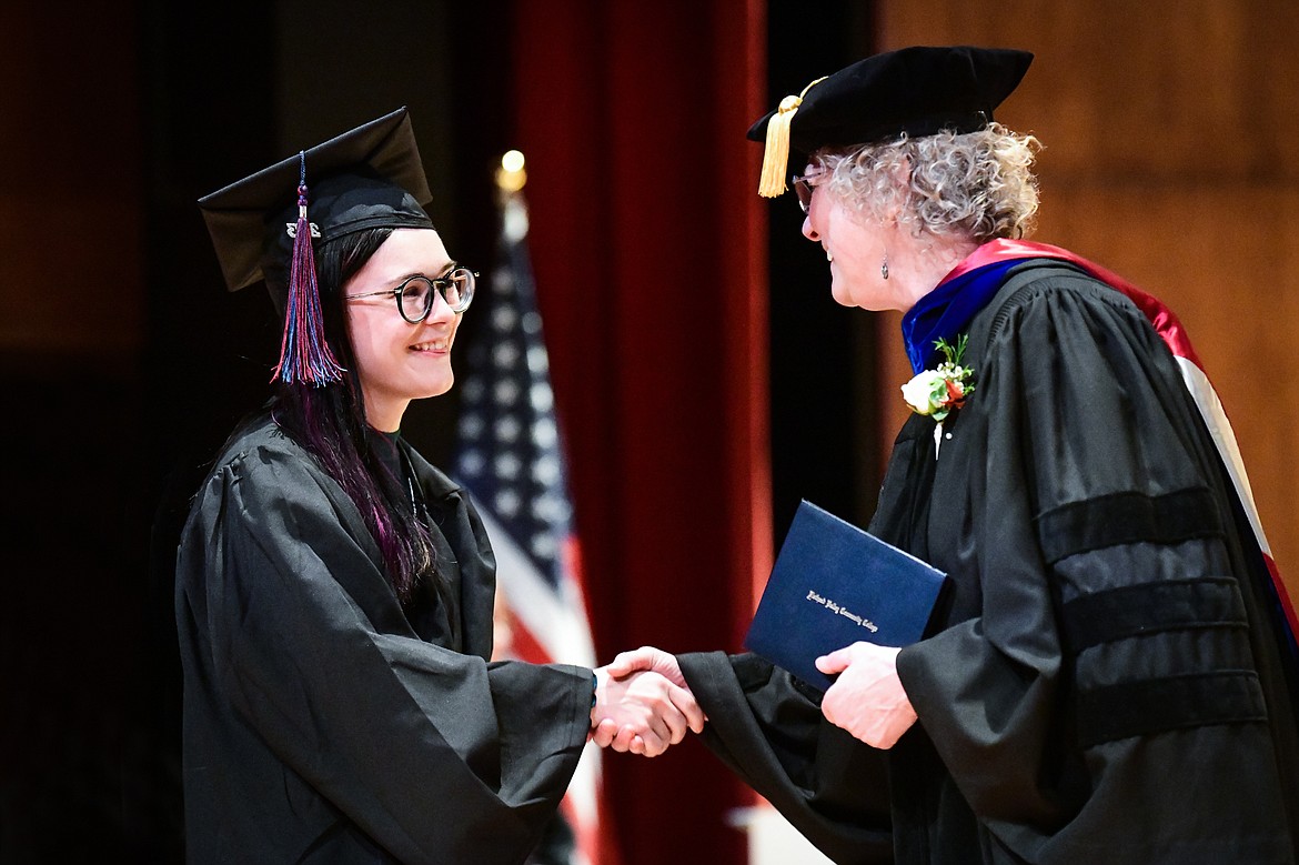 Dr. Chris Clouse, Vice President of Academic and Student Affairs, presents a graduate with her degree at Flathead Valley Community College's Class of 2023 commencement ceremony inside McClaren Hall at the Wachholz College Center on Friday, May 12. A total of 268 graduates were honored receiving 288 degrees and certificates. (Casey Kreider/Daily Inter Lake)