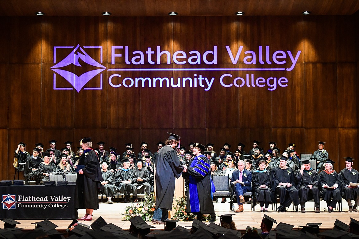 Flathead Valley Community College President Dr. Jane Karas shakes the hand of a graduate after receiving his degree  at FVCC's Class of 2023 commencement ceremony inside McClaren Hall at the Wachholz College Center on Friday, May 12. A total of 268 graduates were honored receiving 288 degrees and certificates. (Casey Kreider/Daily Inter Lake)