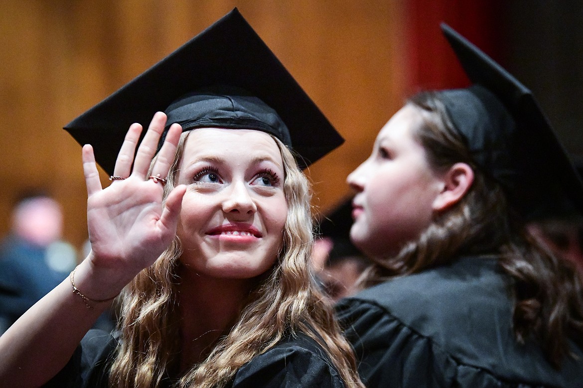 A graduate waves toward family and friends before Flathead Valley Community College's Class of 2023 commencement ceremony inside McClaren Hall at the Wachholz College Center on Friday, May 12. A total of 268 graduates were honored receiving 288 degrees and certificates. (Casey Kreider/Daily Inter Lake)
