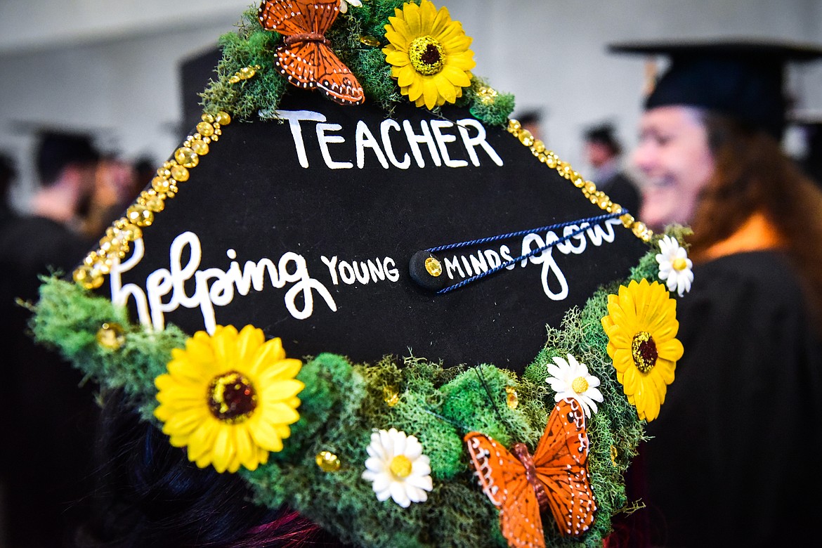 A graduate's decorated mortarboard reads "Teacher helping young minds grow" before Flathead Valley Community College's Class of 2023 commencement ceremony inside McClaren Hall at the Wachholz College Center on Friday, May 12. A total of 268 graduates were honored receiving 288 degrees and certificates. (Casey Kreider/Daily Inter Lake)