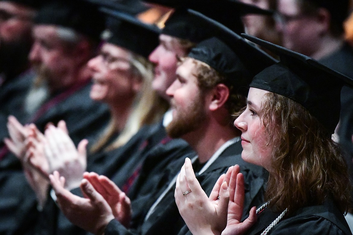 Graduates clap during a speech by Dr. Christina Relyea, of the Science and Engineering Division, at Flathead Valley Community College's Class of 2023 commencement ceremony inside McClaren Hall at the Wachholz College Center on Friday, May 12. A total of 268 graduates were honored receiving 288 degrees and certificates. (Casey Kreider/Daily Inter Lake)