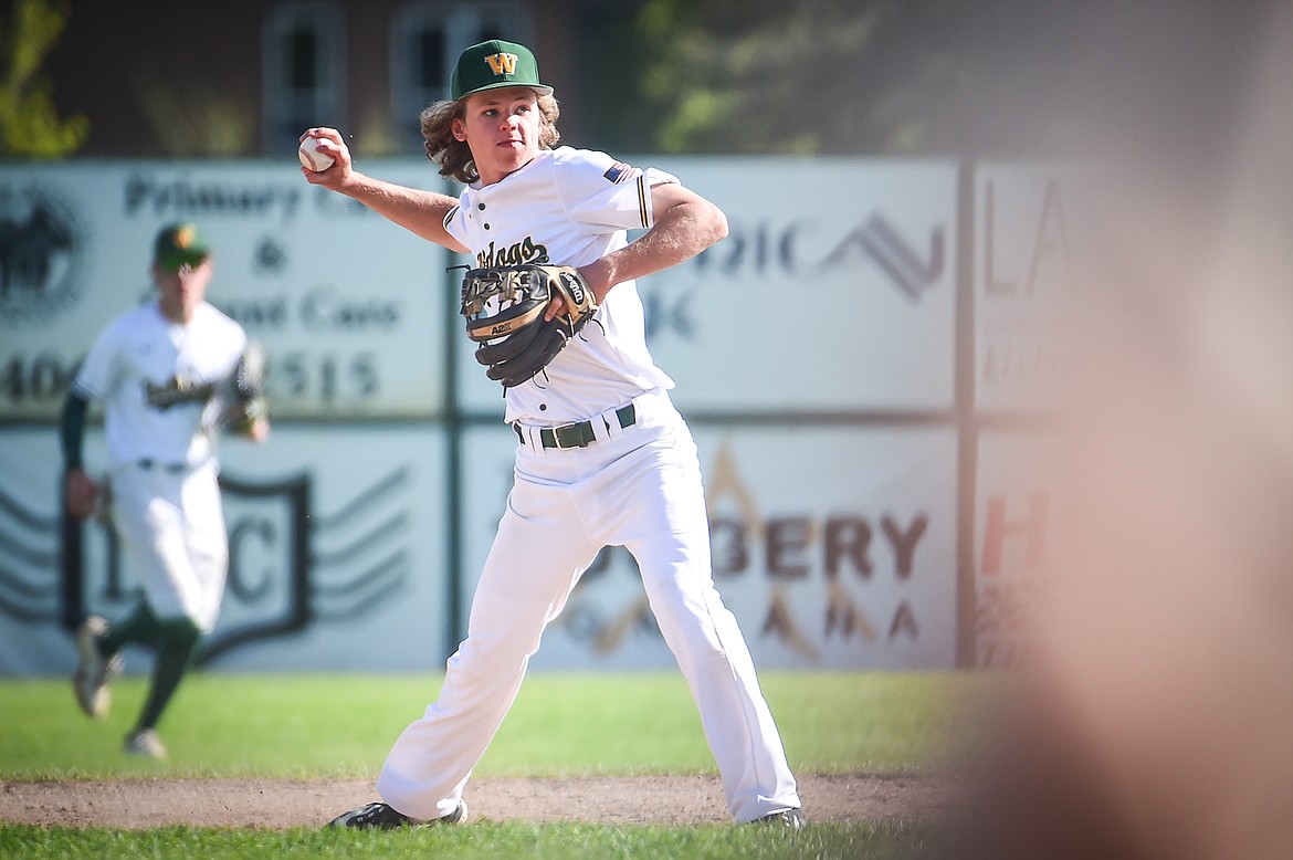 Whitefish shortstop Logan Kunz (15) gathers a ground ball and throws out a Hamilton Broncs runner in the fifth inning in the Sapa-Johnsrud Baseball Invitational at Memorial Field in Whitefish on Saturday, May 13. (Casey Kreider/Daily Inter Lake)