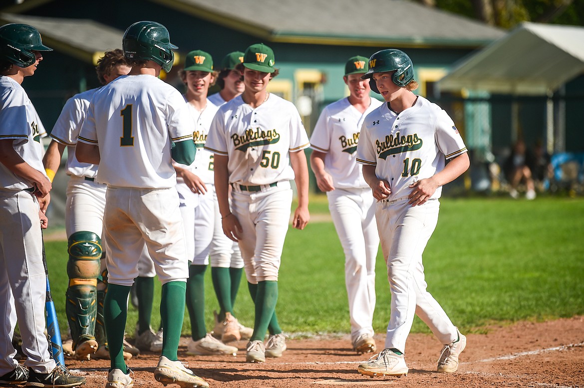 Whitefish's Jake McIntyre (10) touches home after a three-run home run in the sixth inning against Hamilton in the Sapa-Johnsrud Baseball Invitational at Memorial Field in Whitefish on Saturday, May 13. (Casey Kreider/Daily Inter Lake)