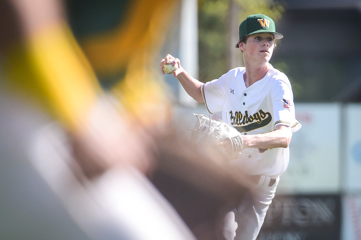 Whitefish shortstop Fisher Fair (22) readies a throw to first as Bulldogs catcher Fynn Ridgeway runs down the line to back up thre throw in the Sapa-Johnsrud Baseball Invitational at Memorial Field in Whitefish on Saturday, May 13. (Casey Kreider/Daily Inter Lake)