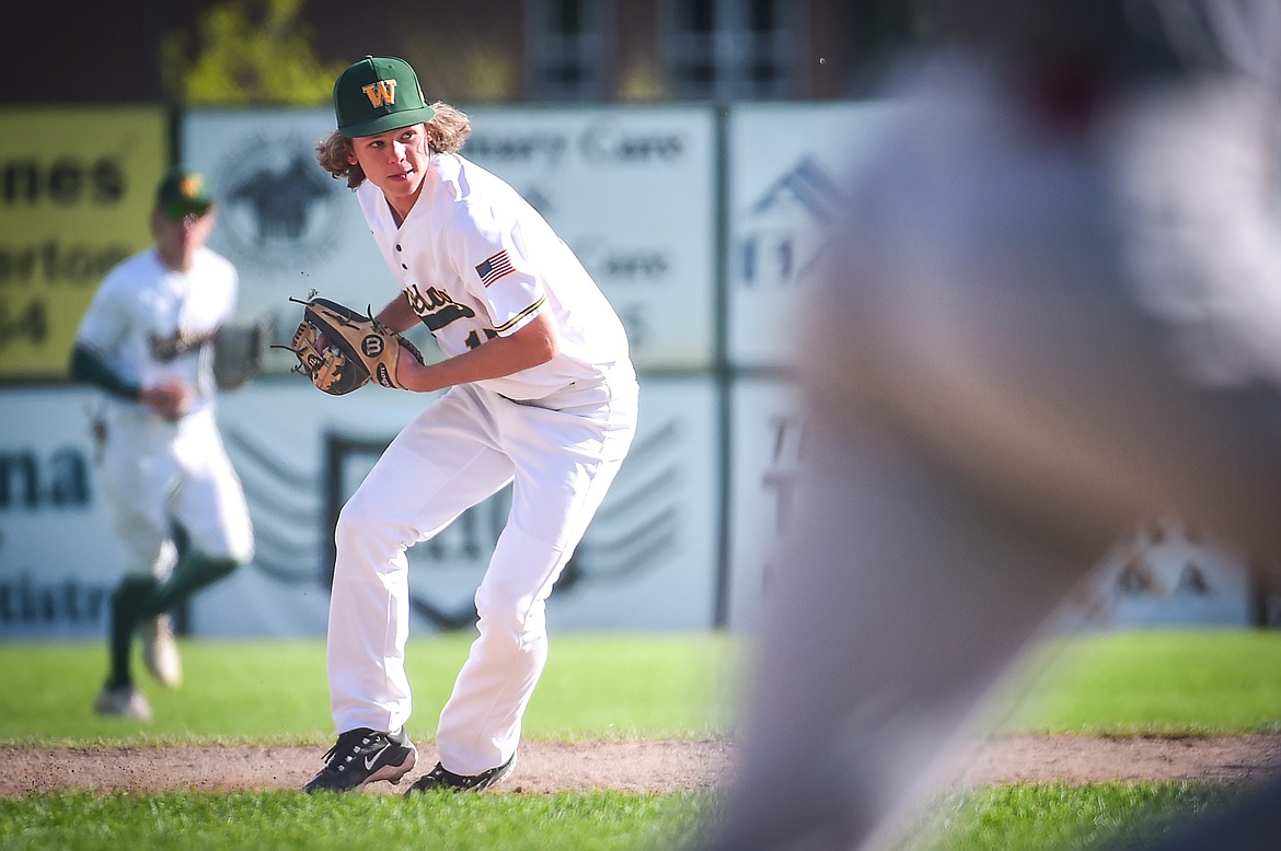 Whitefish shortstop Logan Kunz (15) gathers a ground ball and throws out a Hamilton Broncs runner in the fifth inning in the Sapa-Johnsrud Baseball Invitational at Memorial Field in Whitefish on Saturday, May 13. (Casey Kreider/Daily Inter Lake)