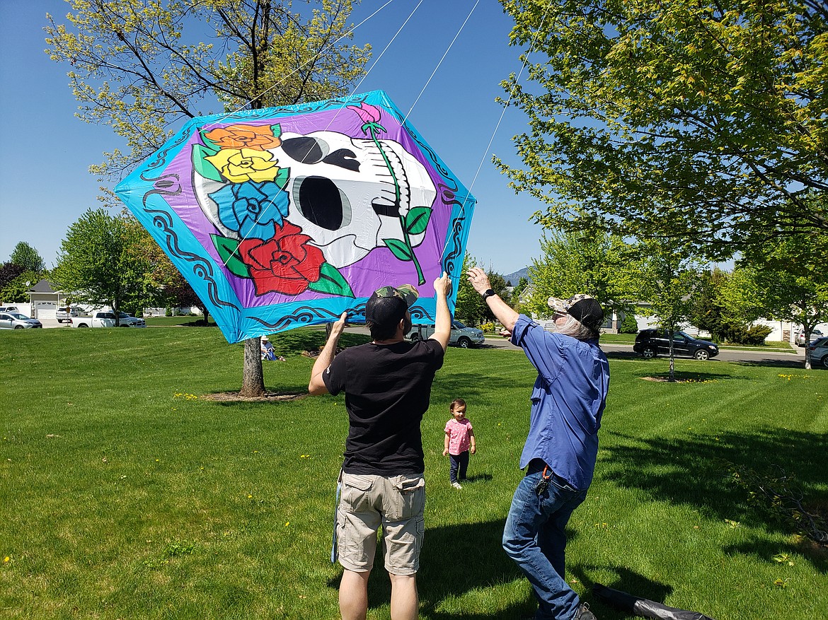 Steve Rezac struggles to release his homemade rokkaku kite from a tree, after it diverted from its course slightly in a light gust at the Hayden kite festival Saturday.