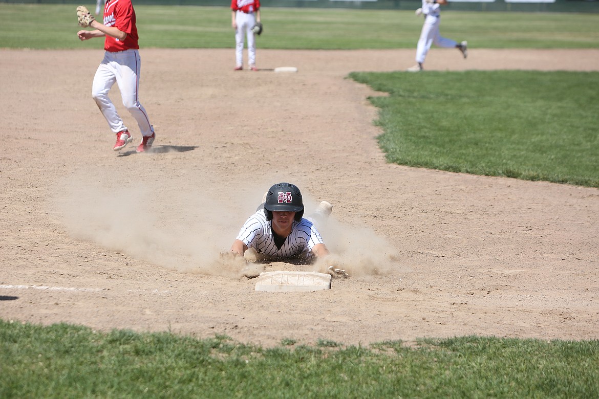 Moses Lake junior Jayce Stuart dives to third base during the bottom of the fifth inning against Eastmont.