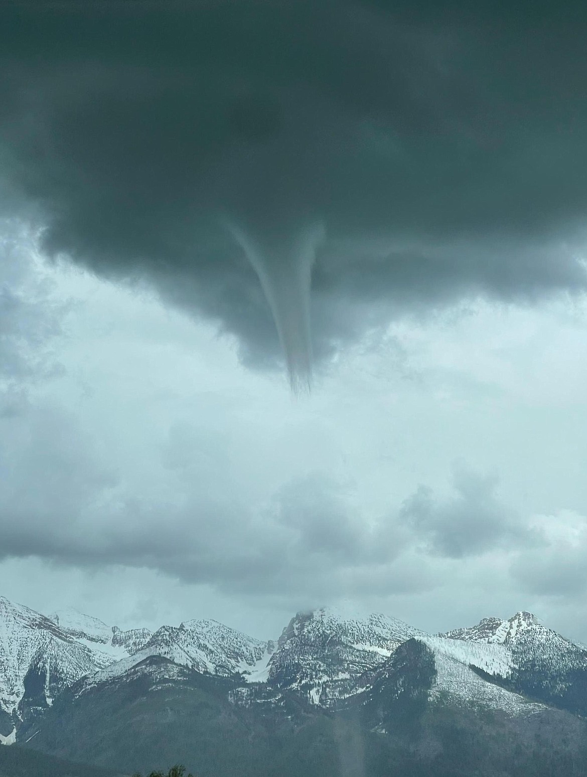 A landspout captivated St. Ignatius-area residents and caused some destruction late last Tuesday afternoon. The rare weather event (at least by Montana standards) forms while a thunderstorm is still gaining momentum and its spinning motion is close to the ground. The funnel shape seemed to form high over the Missions before dropping down to the valley floor. According to Facebook reports, the funnel ripped a roof off a barn, terrified pets and scattered debris. (William Lambson photo)