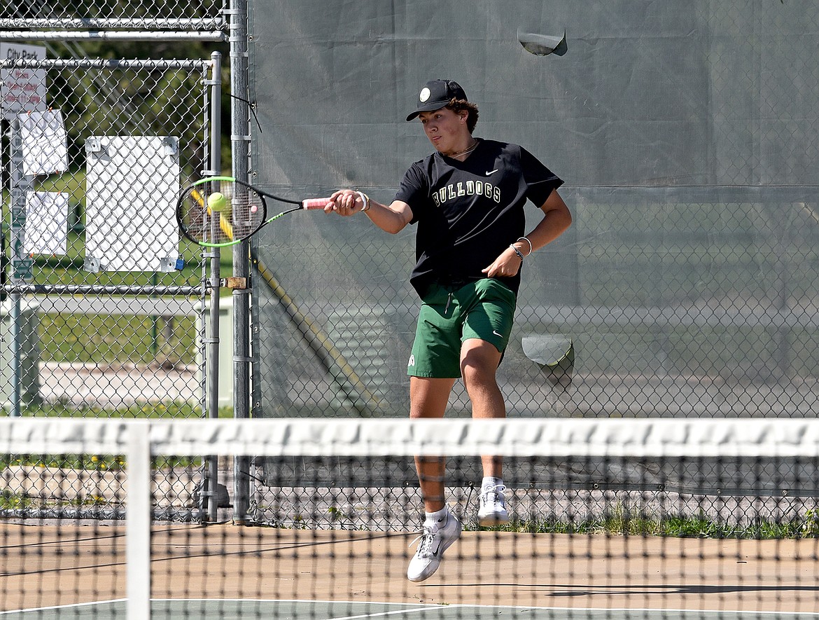 Whitefish junior Mason Kelch hits a return in a match against Polson on Thursday in Whitefish. (Whitney England/Whitefish Pilot)