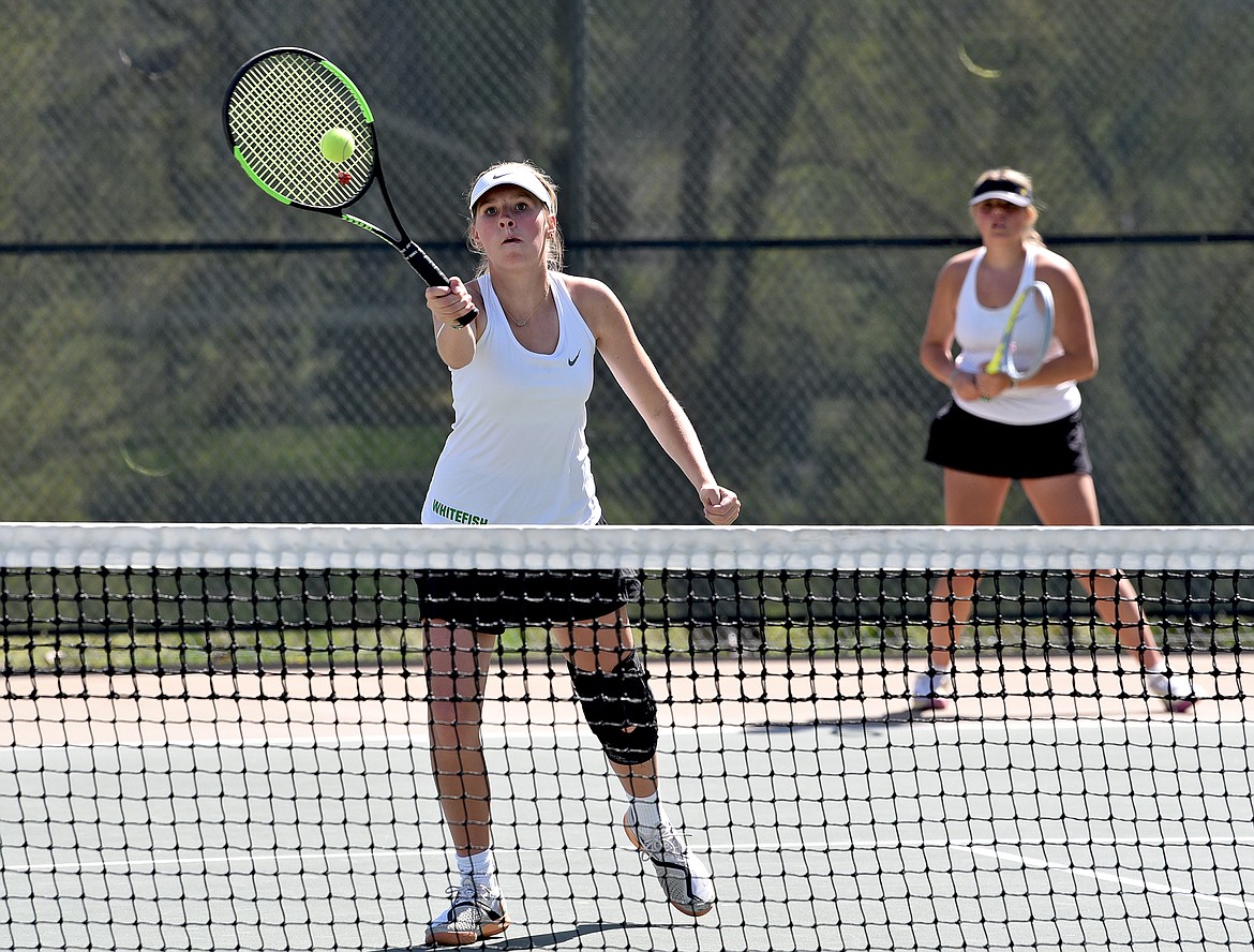 Whitefish's Camry Kelch hits a volley in a doubles match against Polson on Thursday in Whitefish. (Whitney England/Whitefish Pilot)