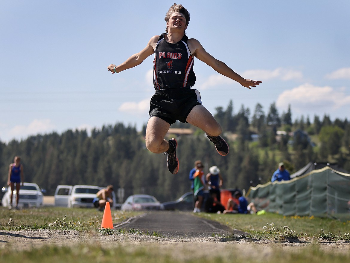 Brenden Vanderwall of Plains uses a leap of 18 feet to finish fifth in the long jump at the 7B District Meet in Eureka Saturday. (Jeremy Weber/Bigfork Eagle)