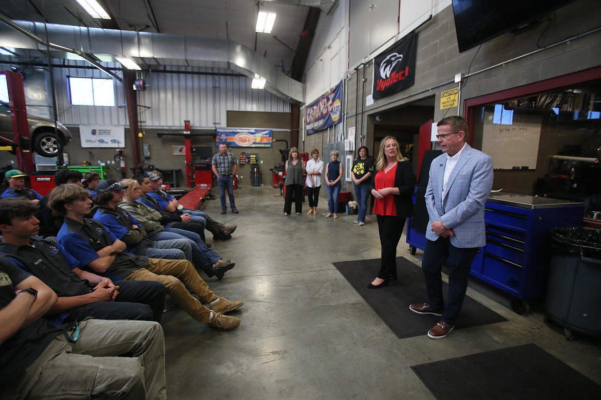 Knudtsen Chevrolet President Eve Knudtsen and Mike White Ford President Mike White share a few words with KTEC students Monday during the name and logo unveiling of a new car exchange program that will give students experience while helping people with transportation challenges. The students chose the name Rides for a Reason.