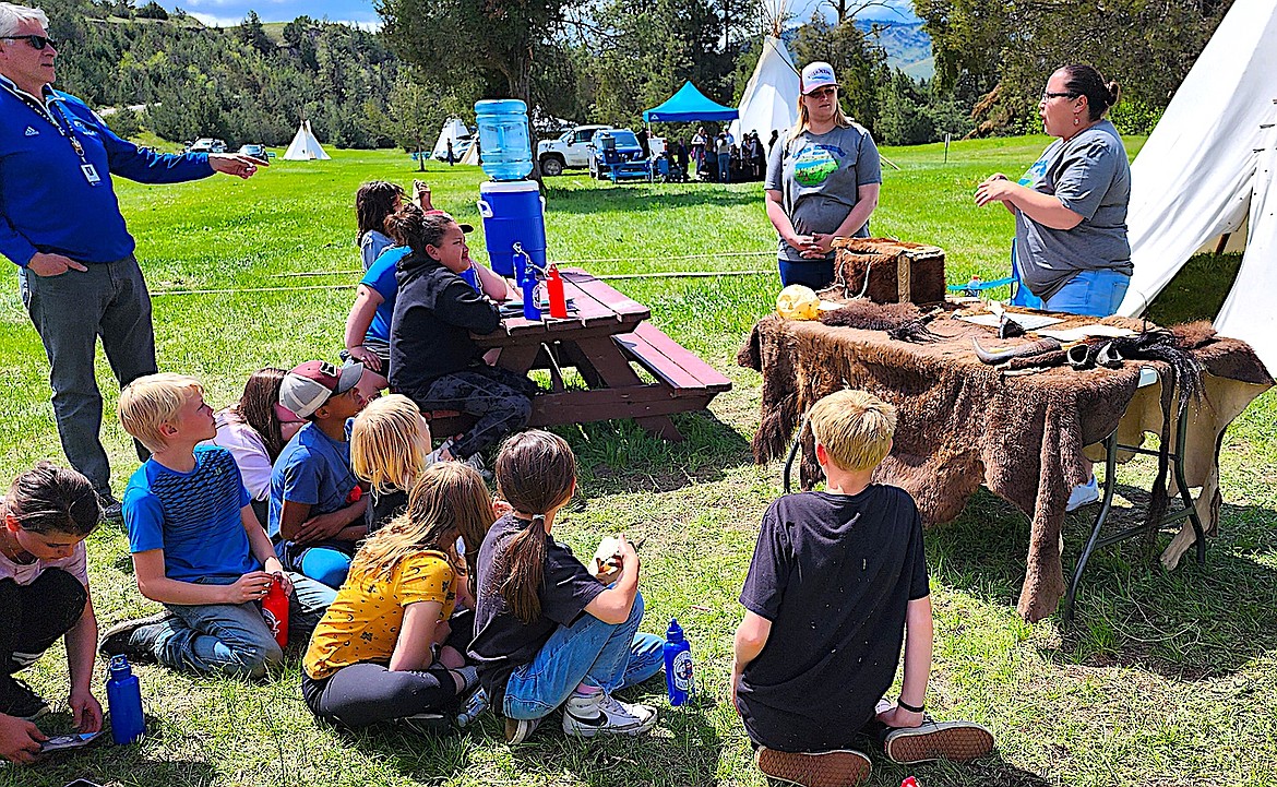 Bison Range employees show students items made from buffalo hides and other parts of bison. (Berl Tiskus/Leader)