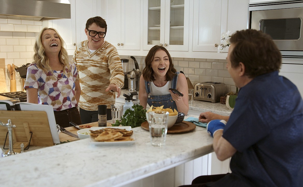 This image released by Apple TV+ shows, from left, Tracy Pollan, Sam Fox, Esme Fox and Michael J. Fox in a scene from the documentary "Still: A Michael J. Fox Movie."