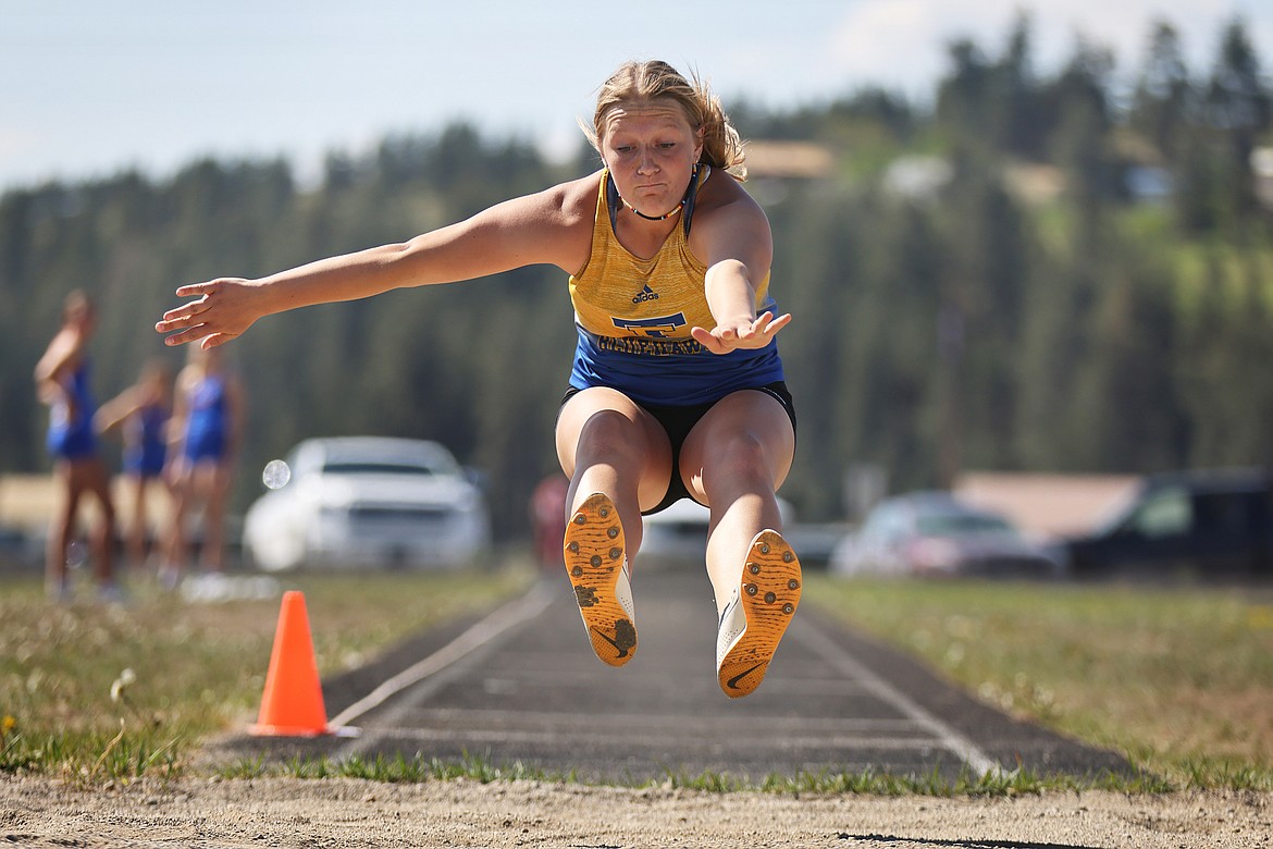 Chesney Lowe of Thompson Falls flies through the air in the long at the 7B District Meet in Eureka Saturday. Lowe's leap of 14 feet, 10 inches propelled her to a third-place finish. (Jeremy Weber/Bigfork Eagle)