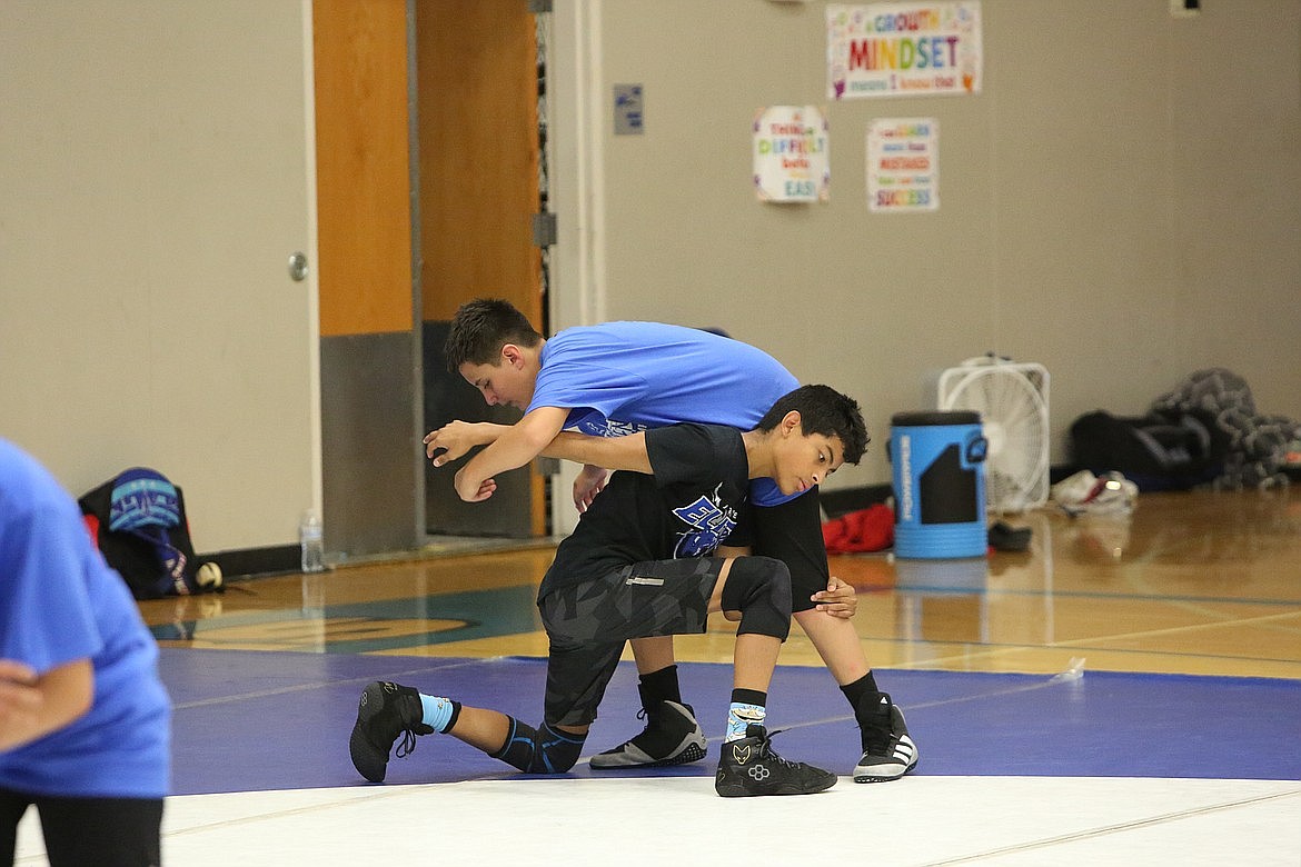 Campers practice wrestling moves against one another at a Warden wrestling summer camp last year. The money raised from the Please Hit Straight tournament goes straight to the camp, assistant coach Alan Martinez said.
