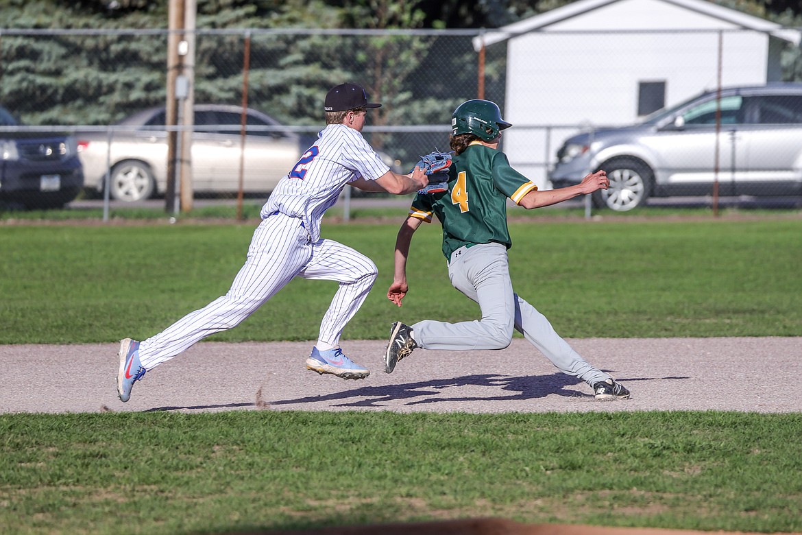 Reggie Sapa tags a pickled Whitefish runner out at home last week. (JP Edge photo)