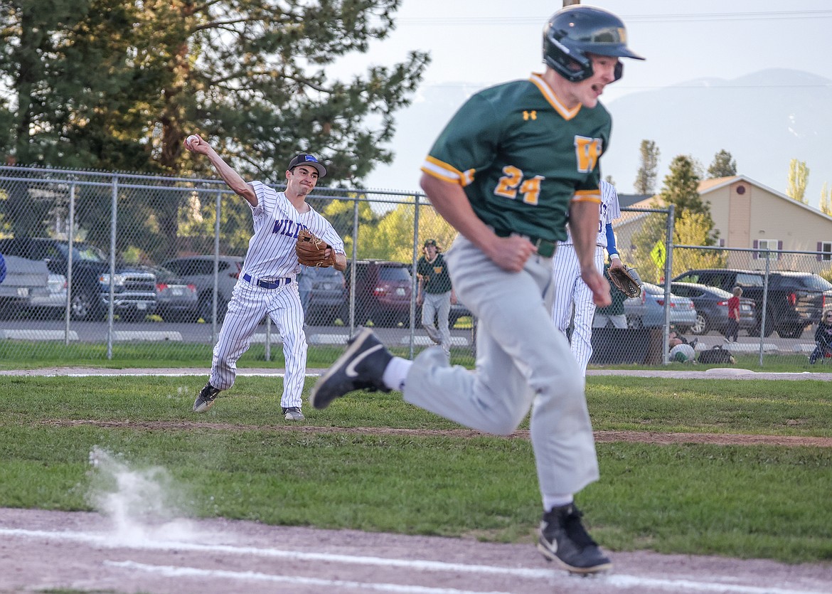 Kellen Kroger throws a Whitefish runner out at first. (JP Edge photo)