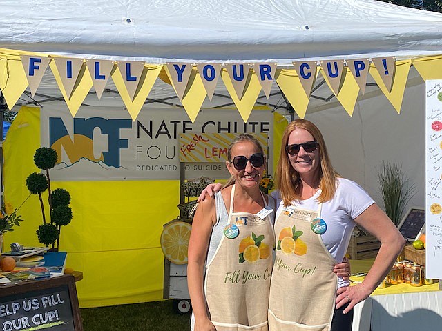 Nate Chute Foundation's Executive Director Kacy Howard (right) and Development Director Nicci Schellinger Daniher promote mental health awareness and suicide prevention at an event. (Provided photo)