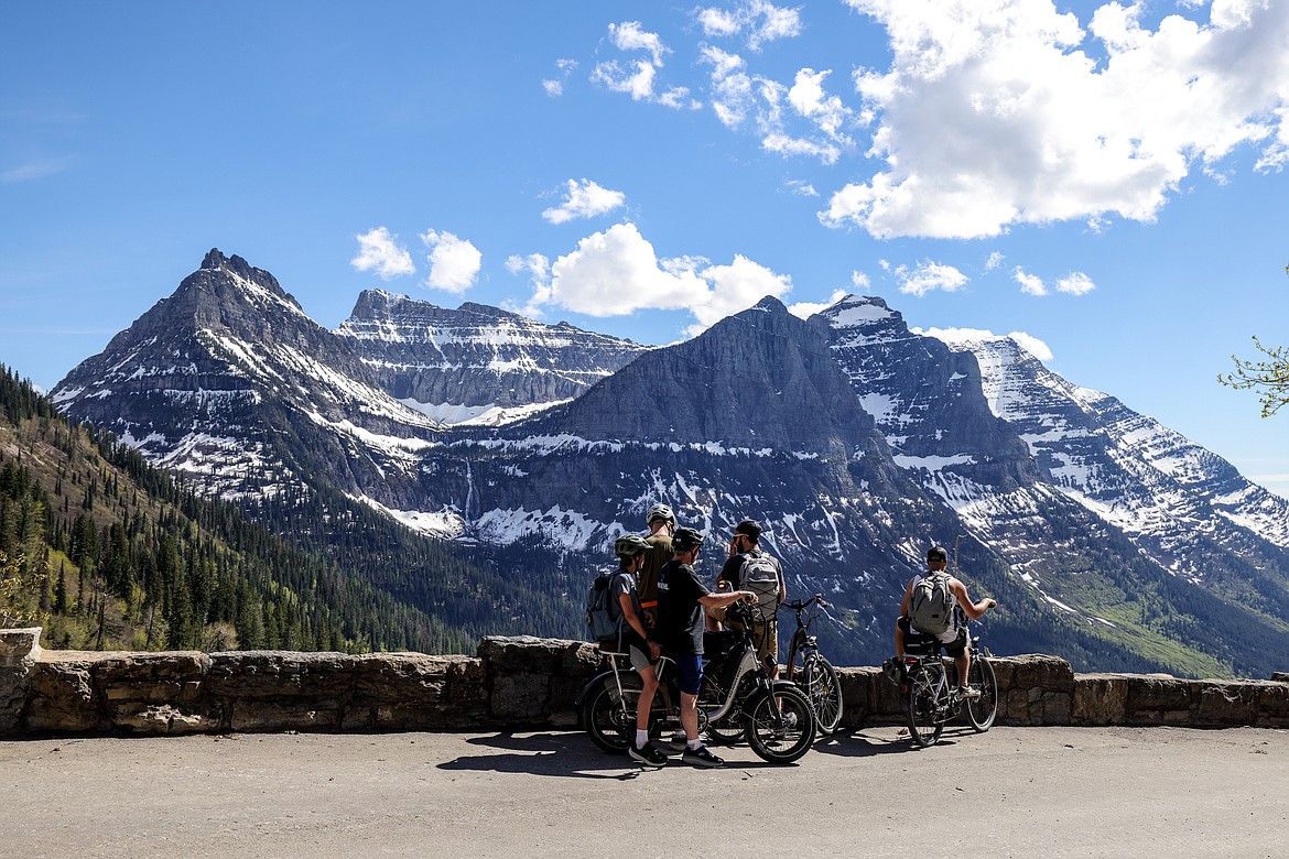 A group of E-Bikers look out towards Bird Woman Falls on Monday. (JP Edge photo)