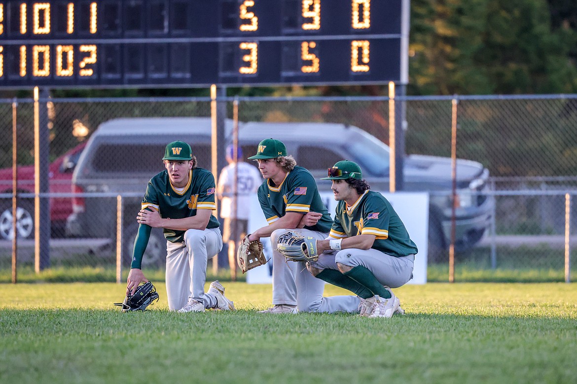 Outfielders Christian Schwaderer, Jake McIntyre and Jacob Polumbus eye the infield while the Bulldogs switch pitchers. (JP Edge photo)